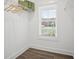Functional walk-in closet with a window, featuring a shelf with wire racks and ample storage at 61 Main St, Moreland, GA 30259