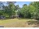 Backyard view of sheds in a fenced-in yard with lots of trees at 3580 Dorris Cir, Douglasville, GA 30135