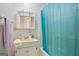 Bathroom with a mirror, sink, vanity and shower tub with a blue shower curtain at 3580 Dorris Cir, Douglasville, GA 30135
