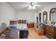 Spacious bedroom with hardwood floors, ceiling fan, and traditional furniture at 3580 Dorris Cir, Douglasville, GA 30135