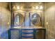 Unique bathroom vanity with dual sinks, ornate cabinetry, mirrors, and vintage-style lighting fixtures at 4173 Raphael St, Covington, GA 30014