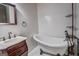 Elegant bathroom featuring a clawfoot tub, classic fixtures, and vanity at 4173 Raphael St, Covington, GA 30014