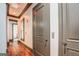 Hallway with hardwood floors, decorative doors, and natural light, offering an inviting atmosphere at 4173 Raphael St, Covington, GA 30014