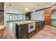 Open concept kitchen island with gas range, built-in microwave, and wine storage at 4173 Raphael St, Covington, GA 30014