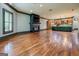 Large living room with wood floors, fireplace, and adjacent kitchen area at 4173 Raphael St, Covington, GA 30014