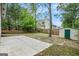 Landscaped backyard featuring mature trees, a storage shed, and patio at 3118 Rockbridge Rd, Avondale Estates, GA 30002