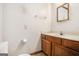 Bathroom with oak vanity, square mirror, and laminate countertop at 3118 Rockbridge Rd, Avondale Estates, GA 30002