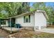 Exterior side view with carport, basement access, and stone foundation at 3118 Rockbridge Rd, Avondale Estates, GA 30002