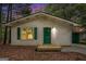 Cozy, one-story home featuring green door and shutters, plus a small, covered front porch at 3118 Rockbridge Rd, Avondale Estates, GA 30002