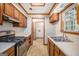 Functional kitchen features wood cabinets, a gas range, and a double-basin sink at 3118 Rockbridge Rd, Avondale Estates, GA 30002