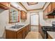 Functional kitchen features wood cabinets, a gas range, and a double-basin sink at 3118 Rockbridge Rd, Avondale Estates, GA 30002