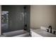 Bathroom with tub and glass-look tiled wall at 135 Church St, Palmetto, GA 30268