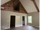 Bedroom with hardwood floors, a high ceiling with wooden beams, and two closets, one of which is open at 135 Church St, Palmetto, GA 30268