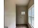 Entryway featuring a front door with sidelight window, hardwood floors, and neutral walls at 135 Church St, Palmetto, GA 30268