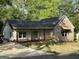 Attractive brick and siding home with covered front porch and newly poured driveway at 135 Church St, Palmetto, GA 30268