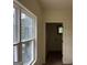 Hallway with hardwood floors, bright neutral walls and access to a laundry room at 135 Church St, Palmetto, GA 30268