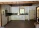 Modern kitchen featuring white cabinets, gray backsplash, stainless steel appliances, and wood beam ceiling at 135 Church St, Palmetto, GA 30268