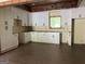 Bright kitchen featuring white cabinets and black hardware, accented by wooden beams overhead at 135 Church St, Palmetto, GA 30268
