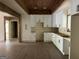 Well-lit kitchen with hardwood floors and white cabinets, enhanced by rustic wooden beam accents at 135 Church St, Palmetto, GA 30268
