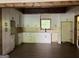 Bright kitchen featuring white cabinets with black hardware, wood ceiling beams, and a window over the sink at 135 Church St, Palmetto, GA 30268