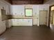 Bright kitchen features white cabinets, hardwood floors, and a window over the countertop area at 135 Church St, Palmetto, GA 30268