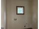 Compact laundry room with a rustic wood-framed window and utility connections at 135 Church St, Palmetto, GA 30268