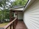 Exterior shot of a covered porch, decorative railing and wood trim accents at 135 Church St, Palmetto, GA 30268