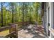 A spacious back deck with wooden railings overlooks mature trees at 231 Breckenridge Ln, Powder Springs, GA 30127