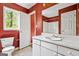 Bathroom featuring red walls, a vanity, and a toilet at 231 Breckenridge Ln, Powder Springs, GA 30127