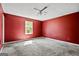 Bedroom featuring red walls, carpet flooring, and a ceiling fan at 231 Breckenridge Ln, Powder Springs, GA 30127