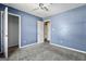 Bedroom featuring blue walls, neutral carpet, and white doors at 231 Breckenridge Ln, Powder Springs, GA 30127