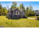 Two-story home featuring an attached garage, gray exterior, bay window, and a walkway leading to the front door at 231 Breckenridge Ln, Powder Springs, GA 30127