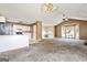 View of an open-concept living room flowing into the kitchen, featuring vaulted ceilings and ample natural light at 231 Breckenridge Ln, Powder Springs, GA 30127