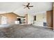 Open-concept living room with neutral walls, vaulted ceilings, carpeted floor, and view of staircase and kitchen at 231 Breckenridge Ln, Powder Springs, GA 30127