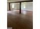 A finished basement features wood floors, neutral colored walls, windows, and support beams at 854 Clearwater Rd, Sharpsburg, GA 30277