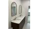 Bathroom showcasing a double sink vanity with marble countertop, wood cabinets, and gold fixtures at 854 Clearwater Rd, Sharpsburg, GA 30277
