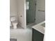 Updated bathroom featuring marble tile and glass enclosed shower at 854 Clearwater Rd, Sharpsburg, GA 30277