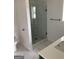 Beautiful bathroom featuring a glass shower with marble tiling, a white vanity, and brushed bronze hardware at 854 Clearwater Rd, Sharpsburg, GA 30277