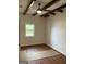 Bedroom with wood-look flooring, natural light, and exposed beam ceiling at 854 Clearwater Rd, Sharpsburg, GA 30277