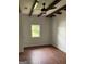 Bright bedroom with wood floors, white walls, and a window overlooking a large yard at 854 Clearwater Rd, Sharpsburg, GA 30277