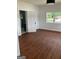 This bedroom has laminate floors, white walls and trim, and a door that leads to a bathroom at 854 Clearwater Rd, Sharpsburg, GA 30277