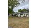 Charming single-story home with white siding, green trim, a manicured lawn, and mature trees at 854 Clearwater Rd, Sharpsburg, GA 30277