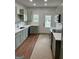 Modern kitchen features sleek gray cabinets, white countertops, stainless steel appliances and wood floors at 854 Clearwater Rd, Sharpsburg, GA 30277