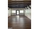 Spacious living room featuring wood floors, exposed beams, and large windows for plenty of natural light at 854 Clearwater Rd, Sharpsburg, GA 30277