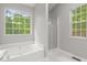 Bright bathroom featuring a shower, tub and window at 40 Kelsey Way, Palmetto, GA 30268