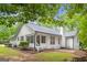 Charming back exterior with screened porch, brick patio, and a well-manicured yard at 40 Kelsey Way, Palmetto, GA 30268