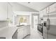 Modern kitchen with quartz countertops, stainless steel appliances, and access to the backyard at 40 Kelsey Way, Palmetto, GA 30268