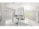 A well lit kitchen, including stainless steel appliances, white cabinets, and an island counter at 40 Kelsey Way, Palmetto, GA 30268
