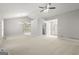 Spacious living room with neutral carpet, a modern ceiling fan, and plenty of natural light at 40 Kelsey Way, Palmetto, GA 30268