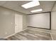 Finished basement area with modern flooring and a large screen at 976 Buckhorn Bnd, Locust Grove, GA 30248